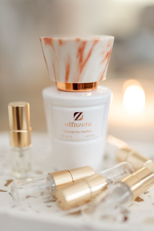 Prestige for Her Olfazeta lifestyle shot with candle and perfume vials
